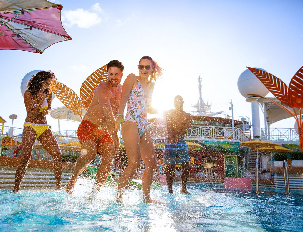 Royal Caribbean cruise vacation guests splashing water in an onboard pool