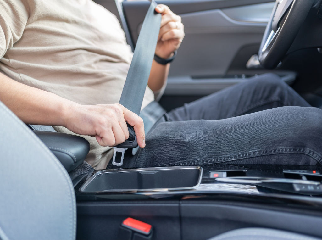 person putting seatbelt on