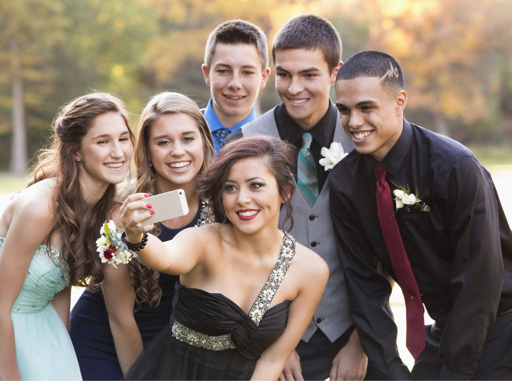 Teens taking a selfie before prom. 