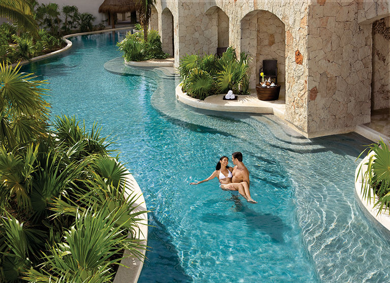A couple relaxing in the laxy river at a resort