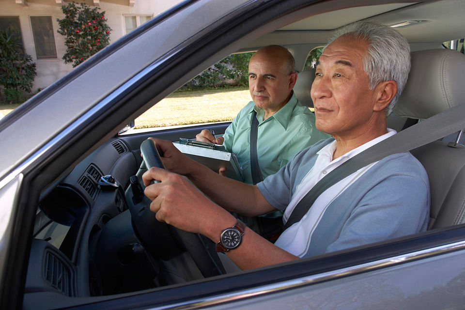 Senior man taking a driving test