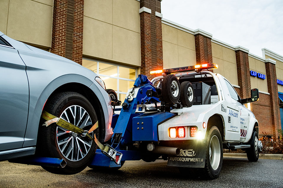Tow truck taking a car into the car shop