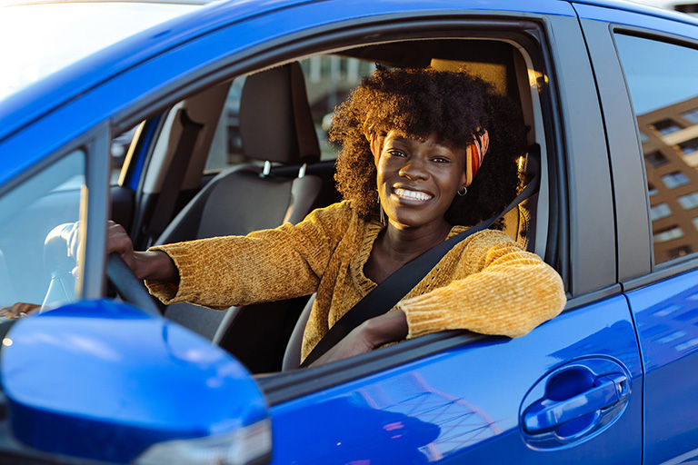 Woman sitting in the car rental that she booked.