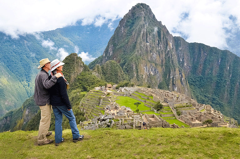 Couple overlooking the Lost city of the Incas, Machu Picchu, Peru