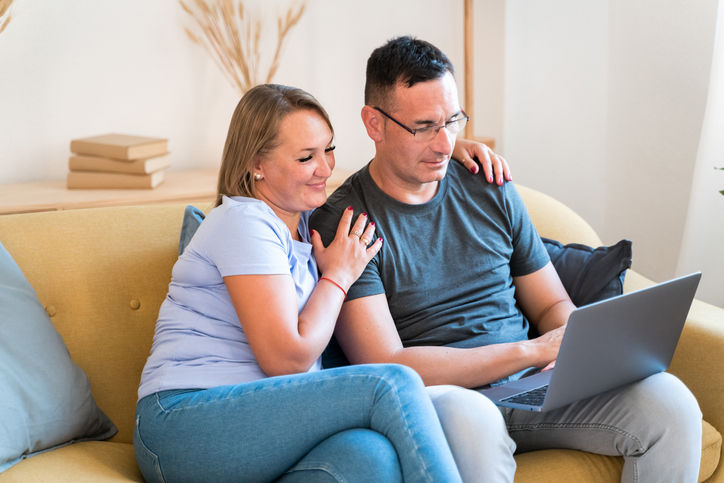 married couple in a videocall in the living room