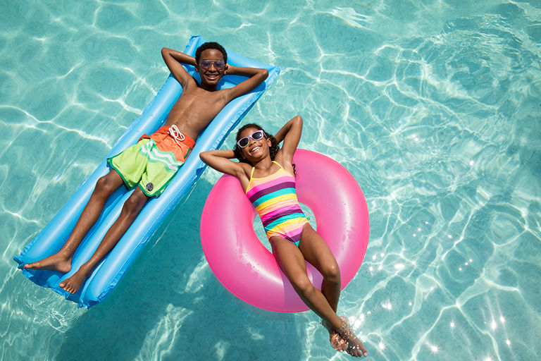 kids in the pool on a floaty