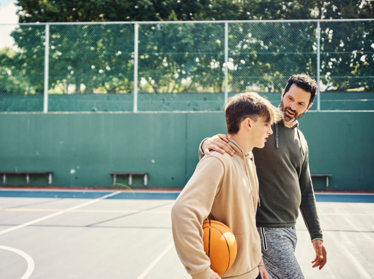 Father and son playing basketball