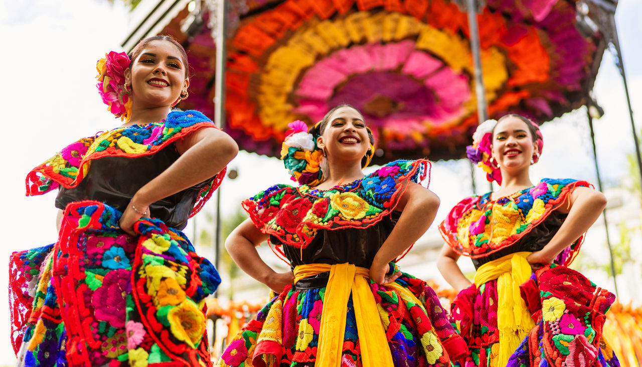 Peruvian women in colorful traditional dance costumes.