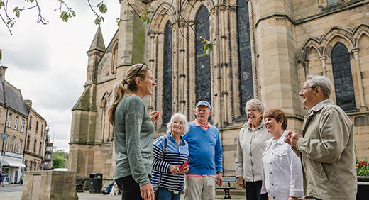 Tour guide talking to a group of people.