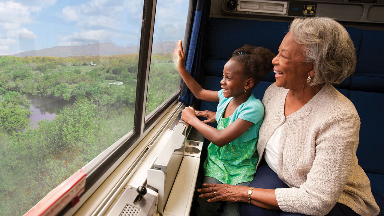 grandmother and granddaughter riding the train.