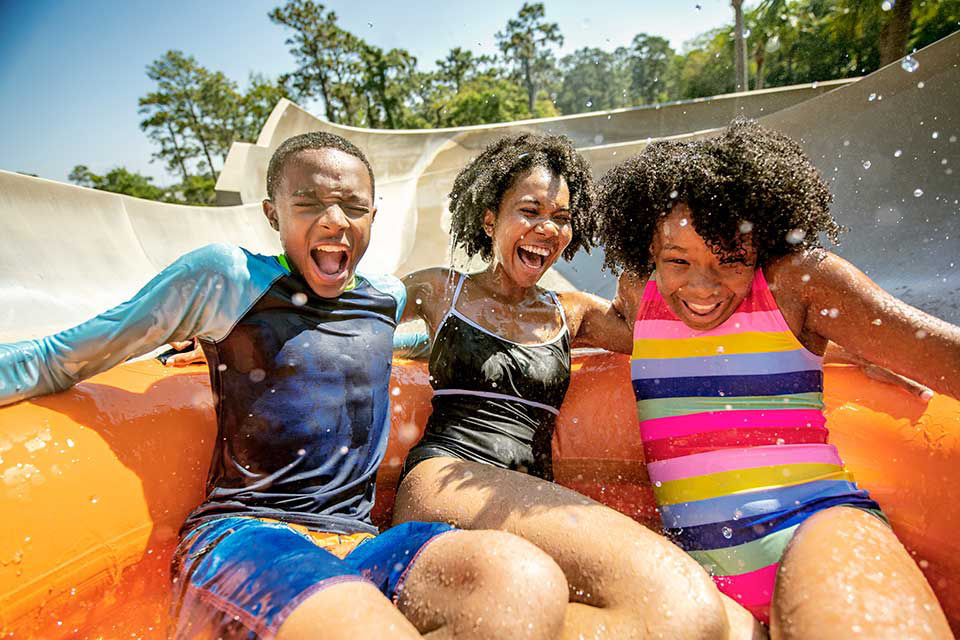 Family goes down water slide at disney's typoon water park.
