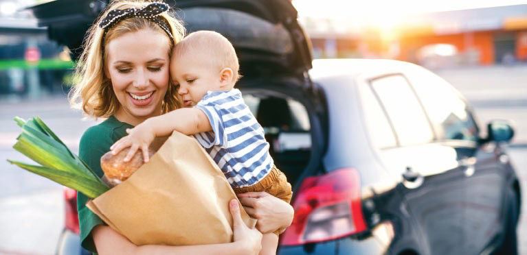 Mom and infant buying groceries.