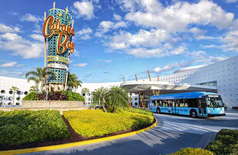 Outside view of cabana bay beach resort hotel at universal with a bus pulling out.
