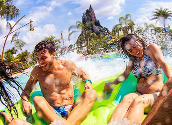 Couple is enjoying getting splashed at one of the rides at universal's water park volcano bay.