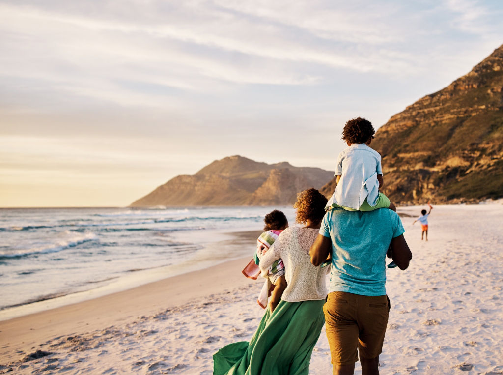 family walking on the beach sunset
