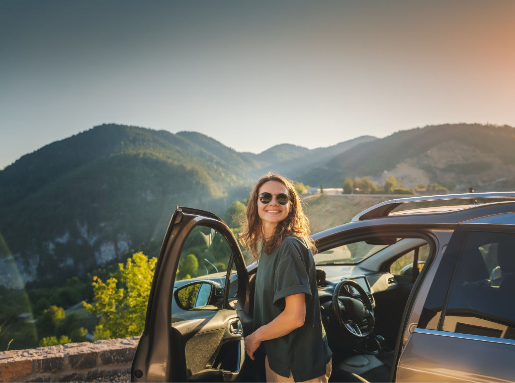 woman on road trip outside the vehicle