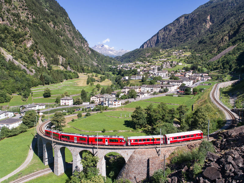 Bernina Express, red train of Bernina over the viaduct of Brusio, Unesco heritage