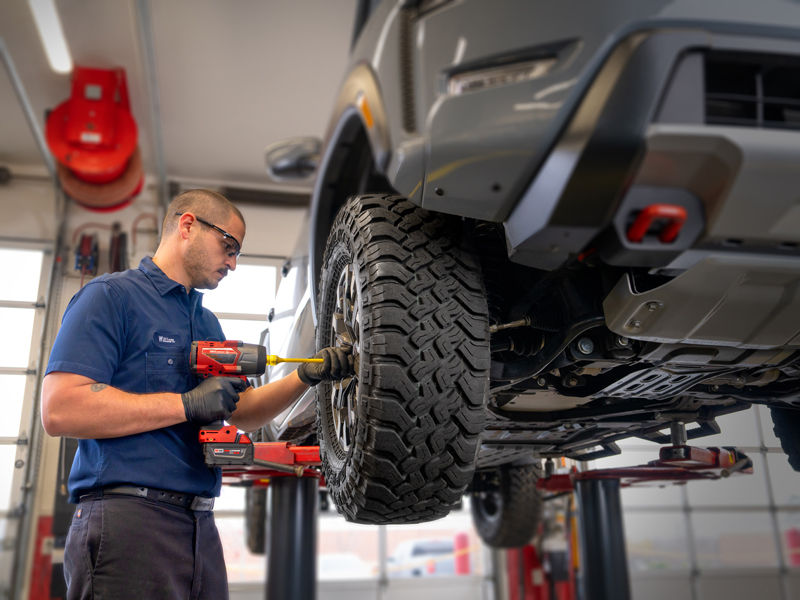 AAA Mechanic working on tire of a vehicle in a garage