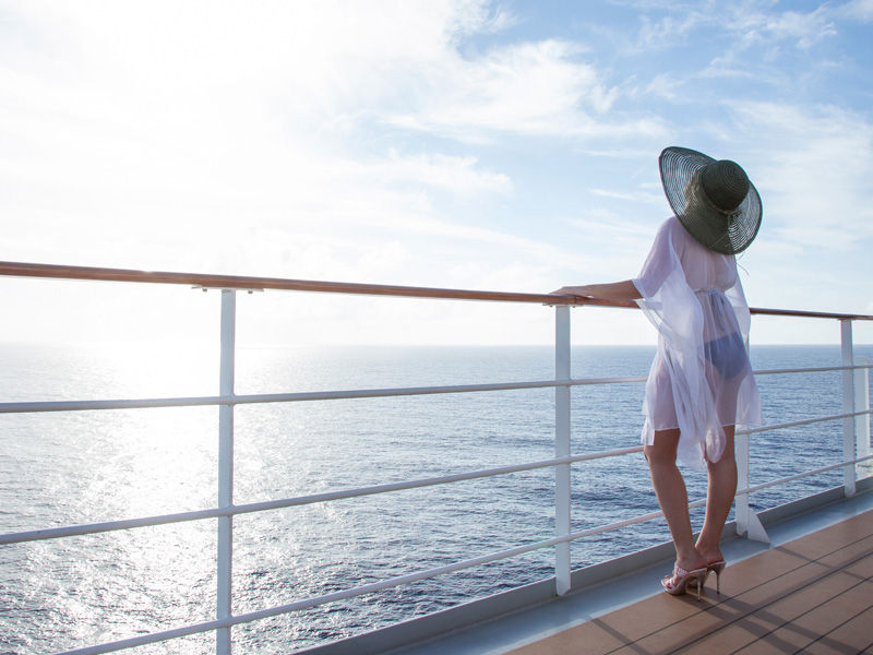 Woman on deck of cruise ship taking in the sun