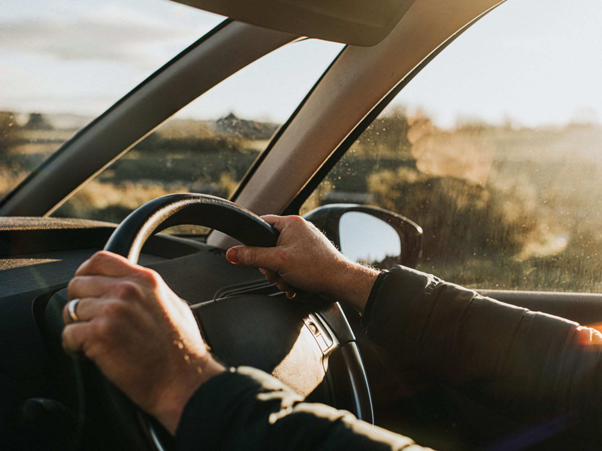Hands on steering wheel.