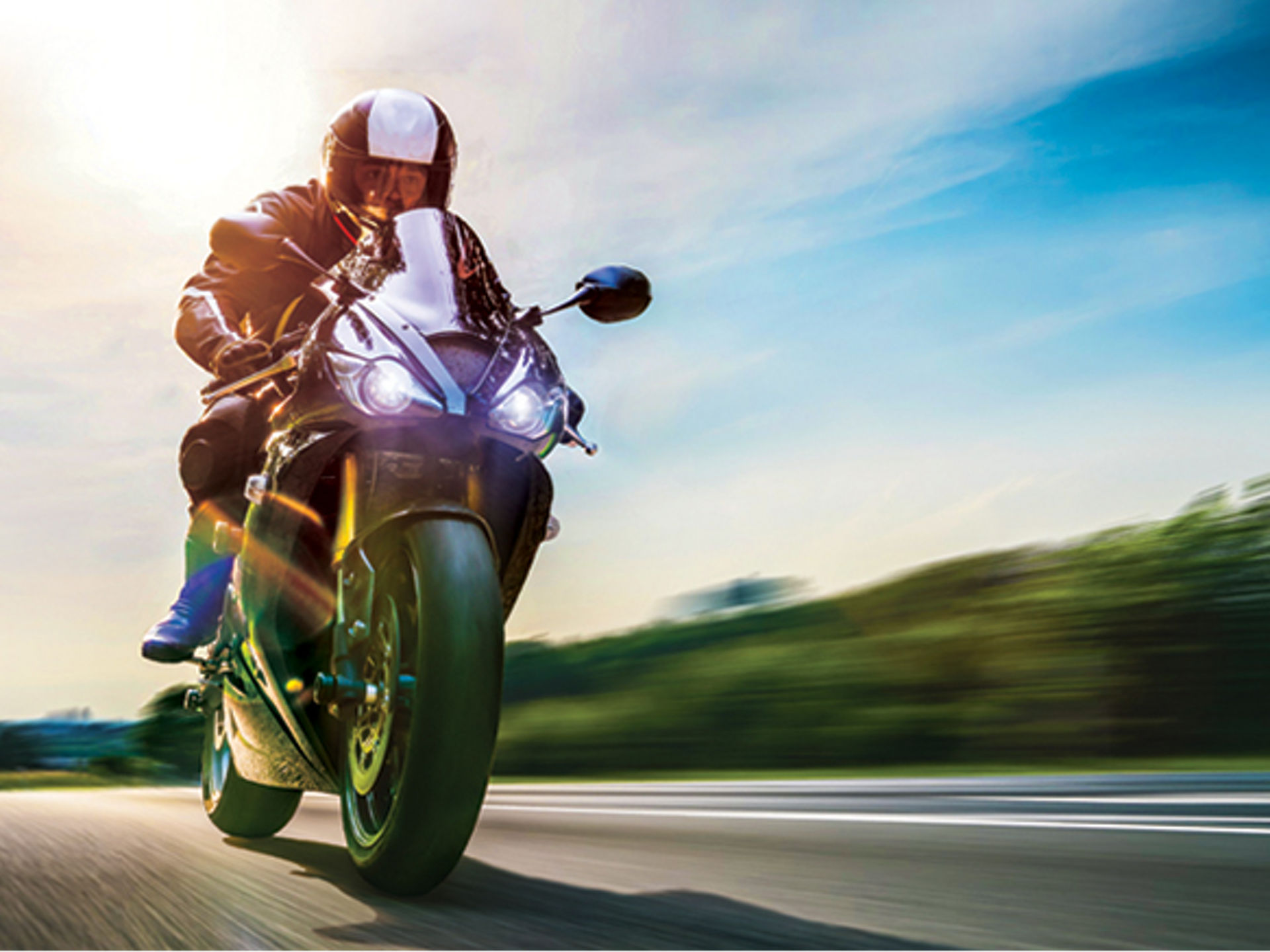 Motorcycle zooming down the highway.